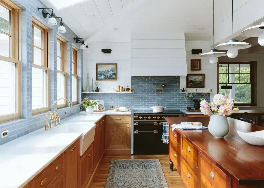 Modern kitchen with blue tiles and wooden cabinets.
