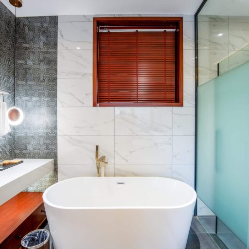 Modern bathroom with freestanding tub and glass shower.