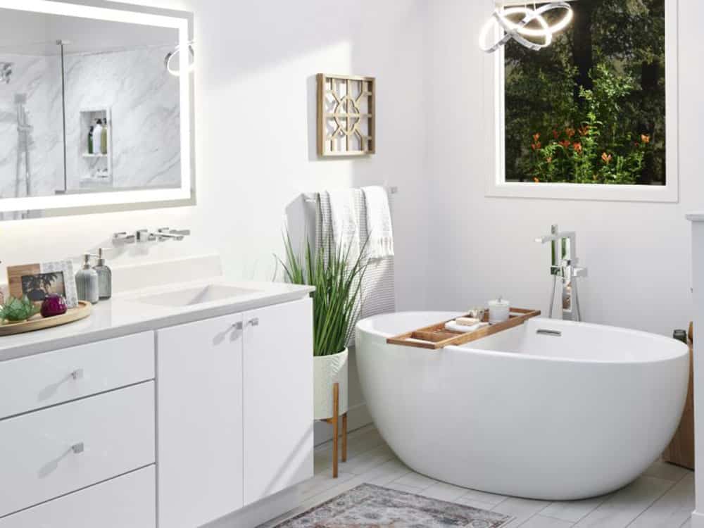 Modern bathroom with freestanding tub and large window.