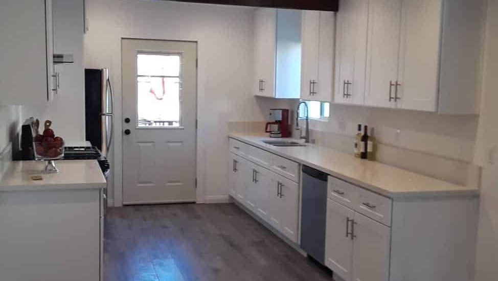 Modern white kitchen with stainless steel appliances