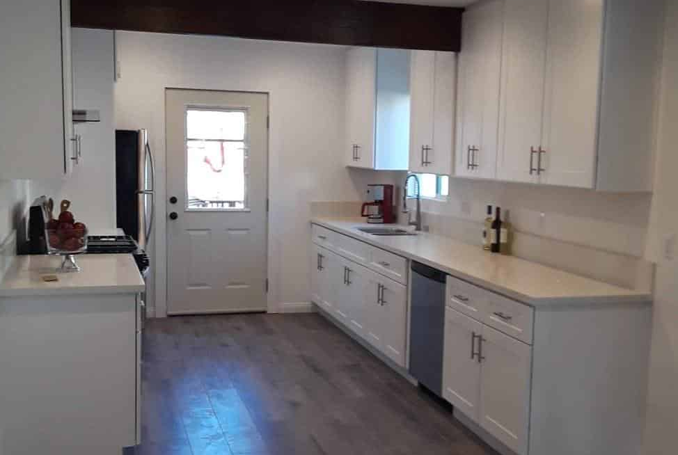 Modern white kitchen with stainless steel appliances