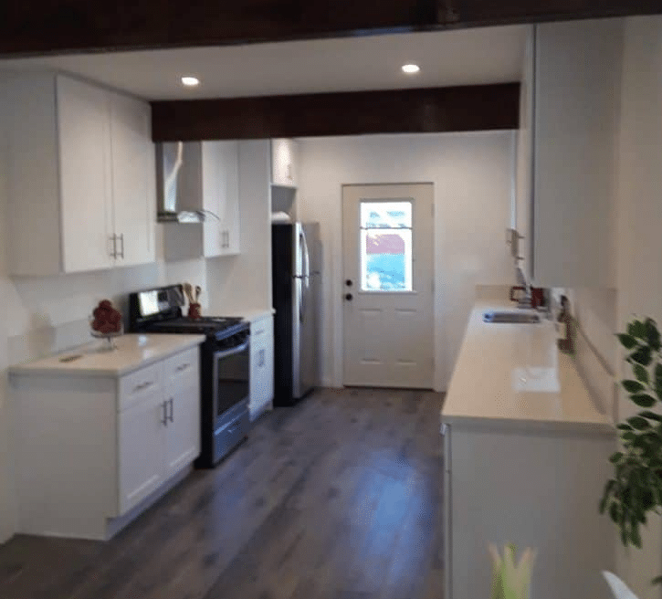 Modern white galley kitchen with stainless appliances