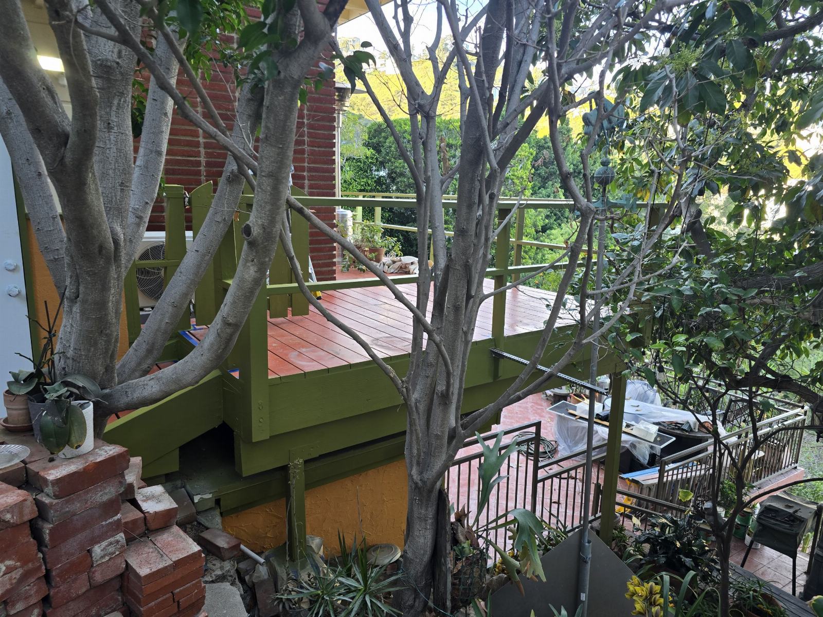 Elevated wood deck with olive green painted framing and railings — Hollywood Contractor Corp