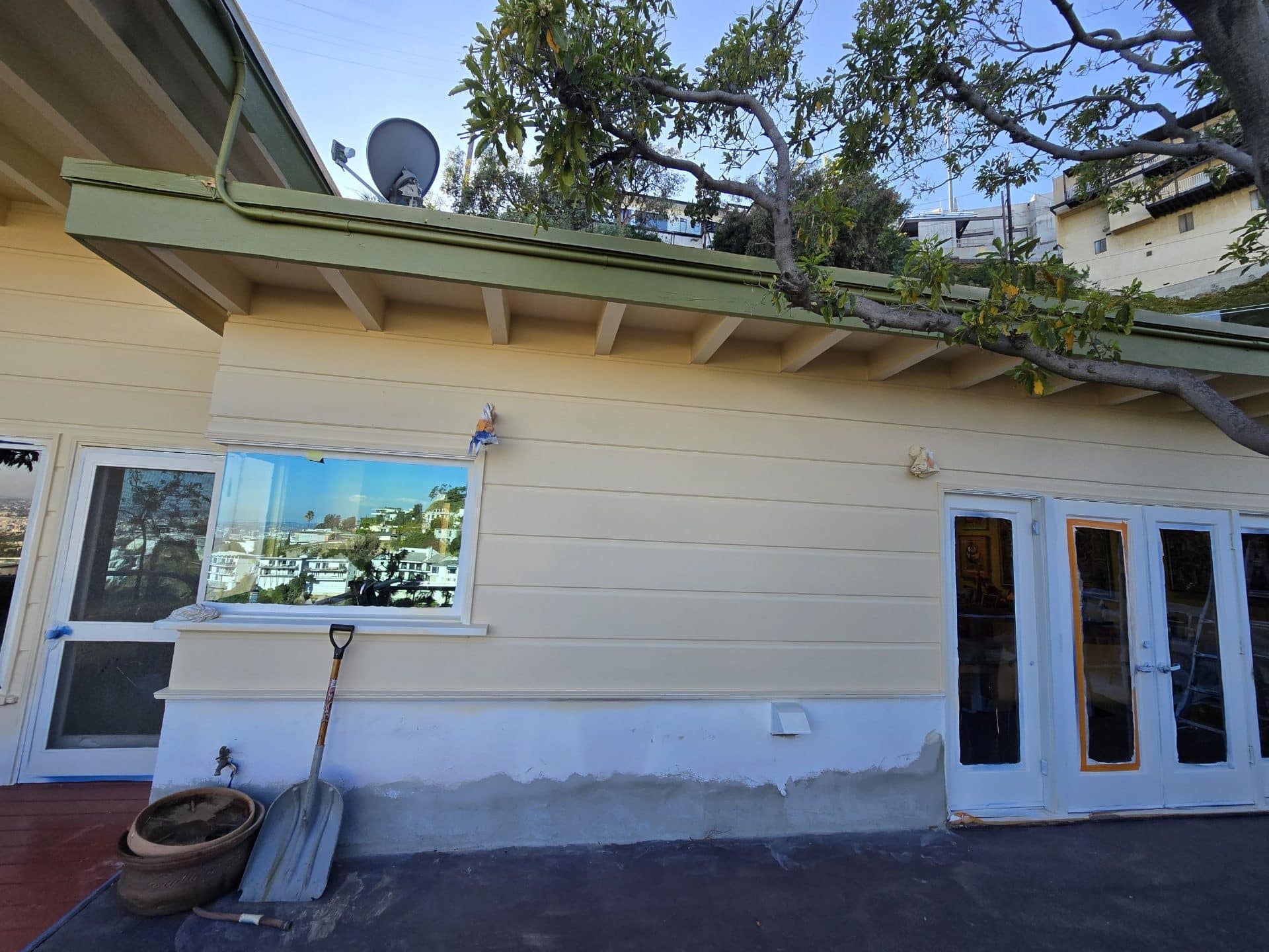 Freshly painted lap siding, eaves, trim, and French doors exterior | Hollywood Contractor Corp Freshly painted lap siding, eaves, trim, and French doors exterior — Hollywood Contractor Corp