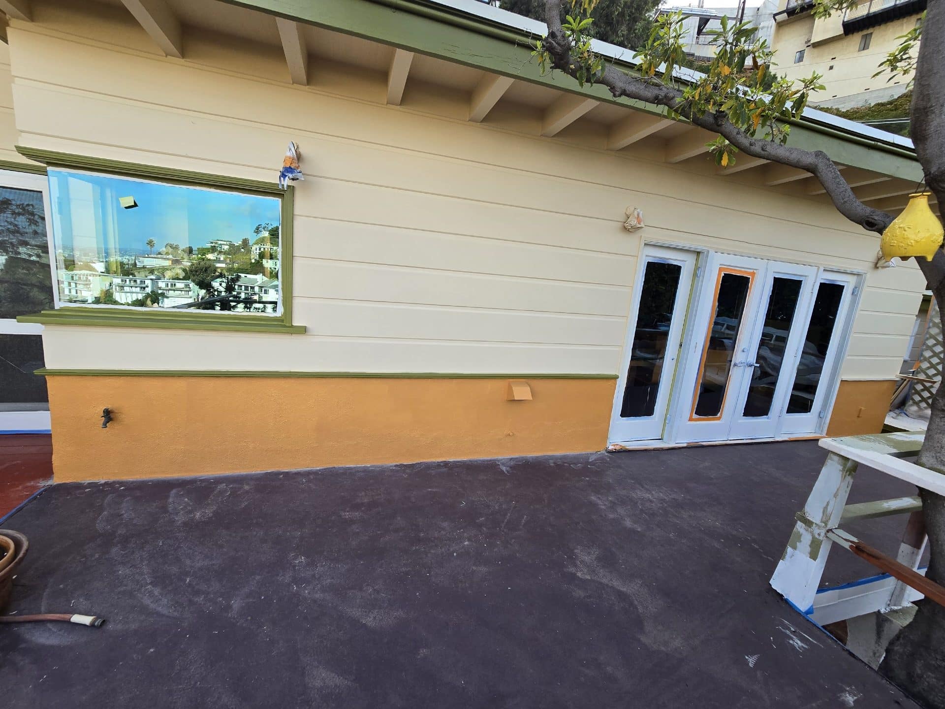 Exterior repaint with stucco base, lap siding, green trim, French doors — Hollywood Contractor Corp