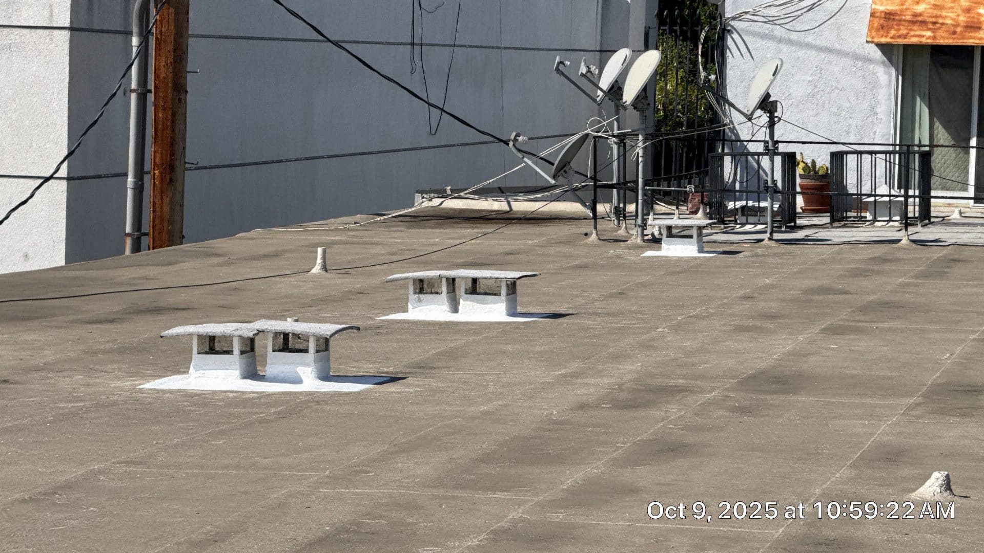 Flat roof with vent caps, satellite dishes, and metal railing in West Hollywood | Hollywood Contractor Corp Flat roof with vent caps, satellite dishes, and metal railing — West Hollywood — Hollywood Contractor Corp