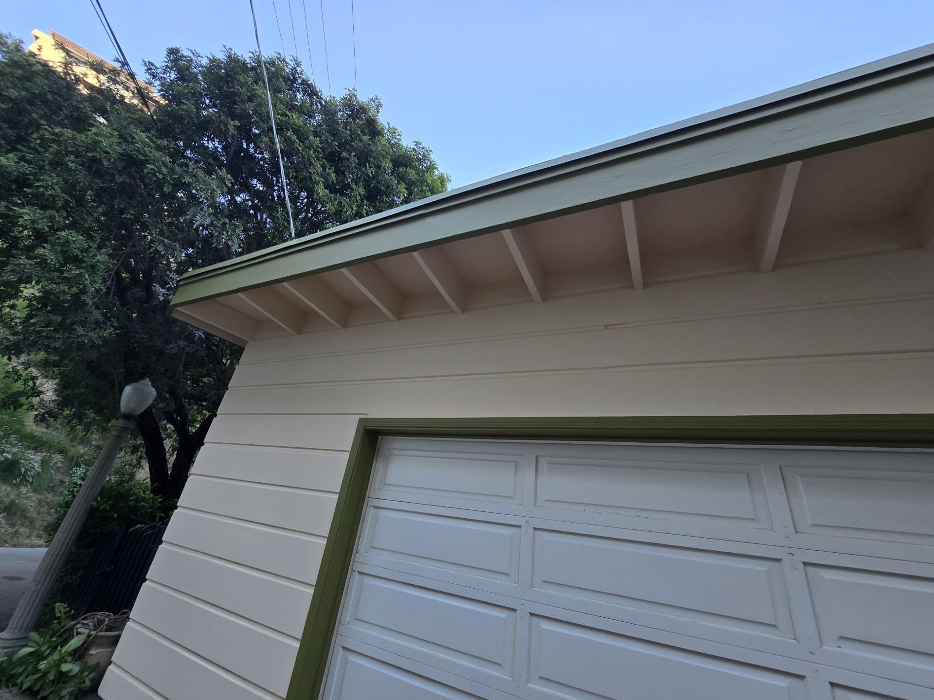 Painted wood soffit, fascia, siding, and garage door exterior — Hollywood Contractor Corp