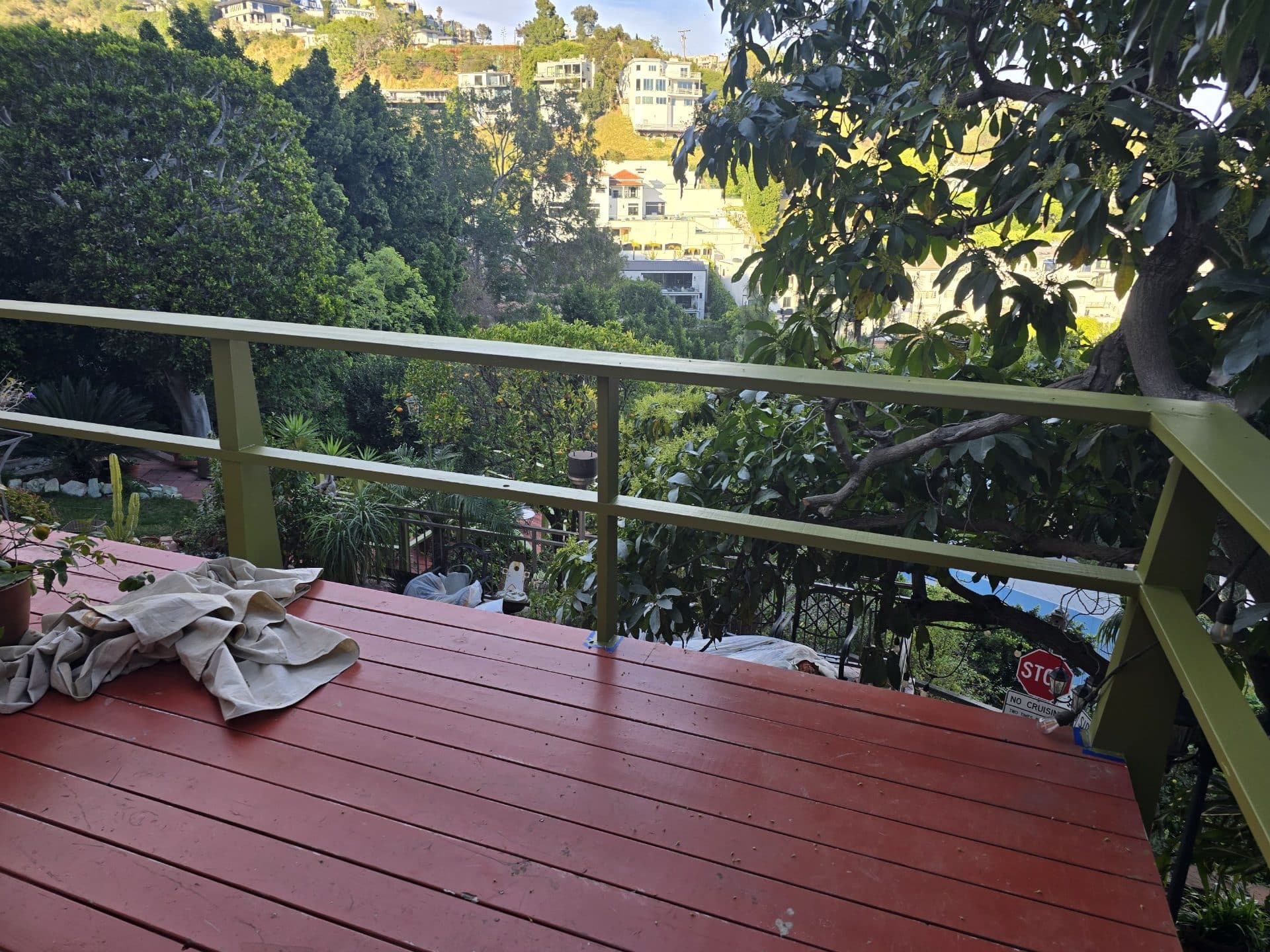 Freshly painted red wood deck with yellow-green steel railing — Hollywood Contractor Corp