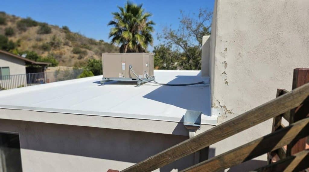 Flat TPO membrane roof on a mid-century modern California home with rooftop HVAC unit
